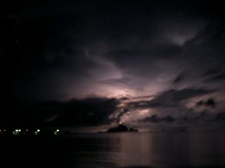 View of a storm with the lightning hitting the island in the distance